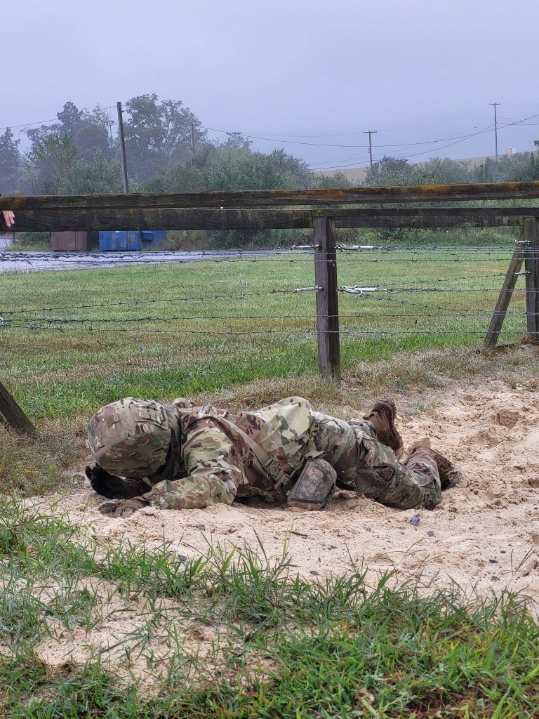 Soldier in Class C uniform, in low crawl position
